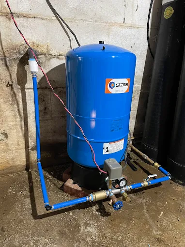 A water pressure tank setup by Titan Plumbing & Drains ensures reliable water flow in a home.