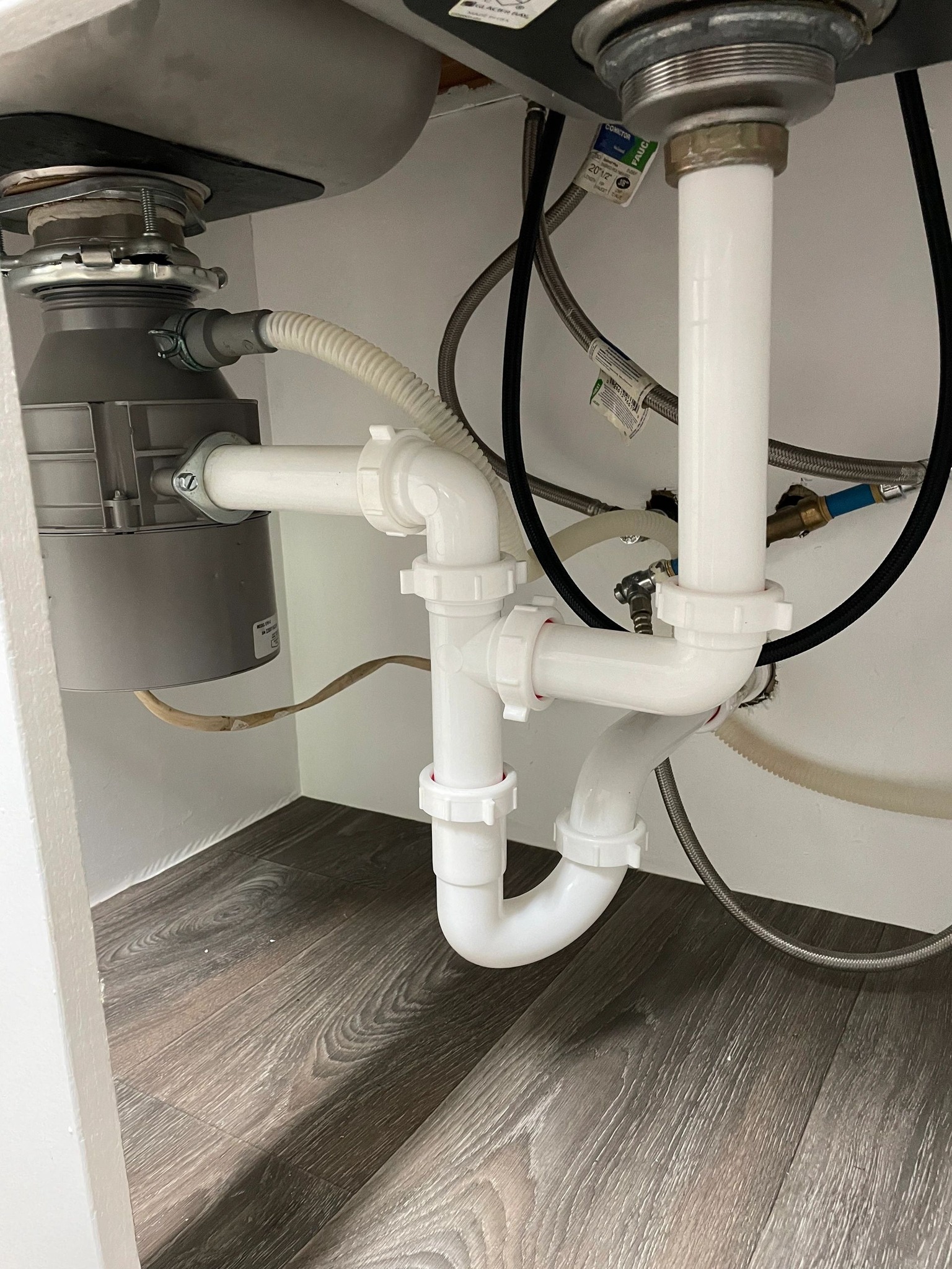 Titan Plumbing & Drains shows a kitchen sink area, highlighting pipe and drain repair services.