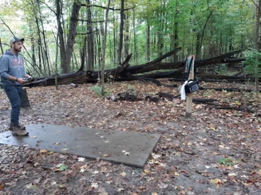 A man talks about needing Titan Plumbing & Drains for help with drain cleaning in Ohio while playing disc golf.