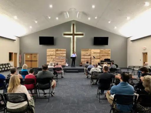 Titan Plumbing & Drains supports local community events, shown by a gathering inside a church during a presentation.
