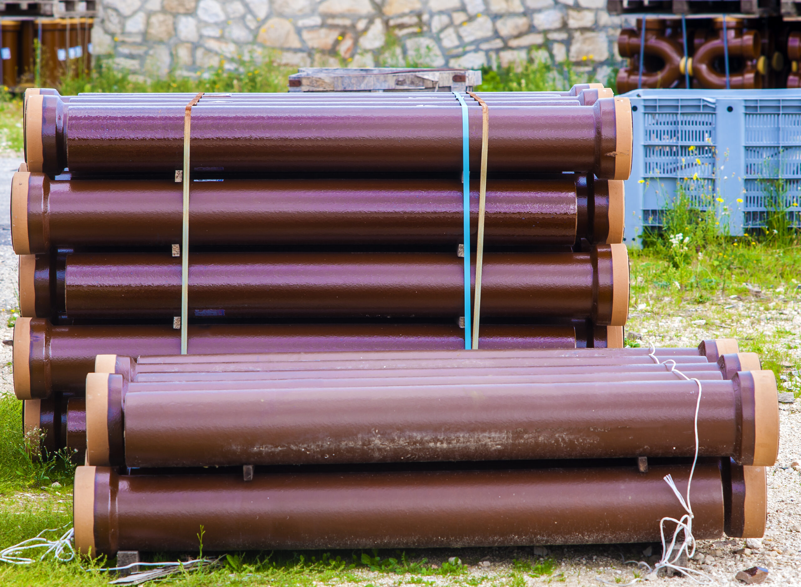 Titan Plumbing & Drains sewer pipes stacked outside, ready for installation or repair projects.