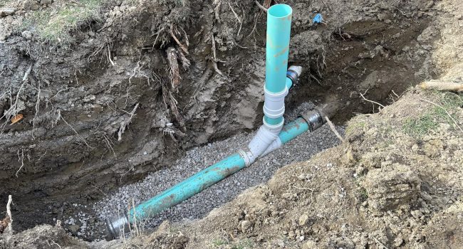 Titan Plumbing & Drains installing underground pipes for a new water system connection.